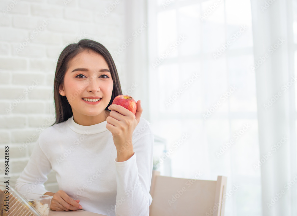 asian beauty woman holding apple. smiley face female eating apple organic fruit in house with copy space. asian beauty woman holding apple. smiley face female eating apple organic fruit in house with copy space.