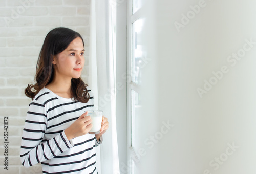 asian beauty woman friends standing and holding cup of milk close window and curtain in morning with copy space.