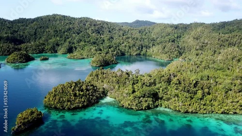 Piaynemo island landscape in the Raja Ampat archipelago Indonesia, Aerial pan right reveal shot photo