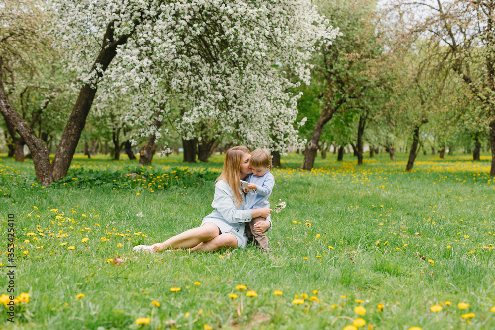 Mom with a child plays in the garden. Mom and son walk in the park. Relations between mom and son. Mom with a child plays in the garden. Mom and son walk in the park. Relations between mom and son.