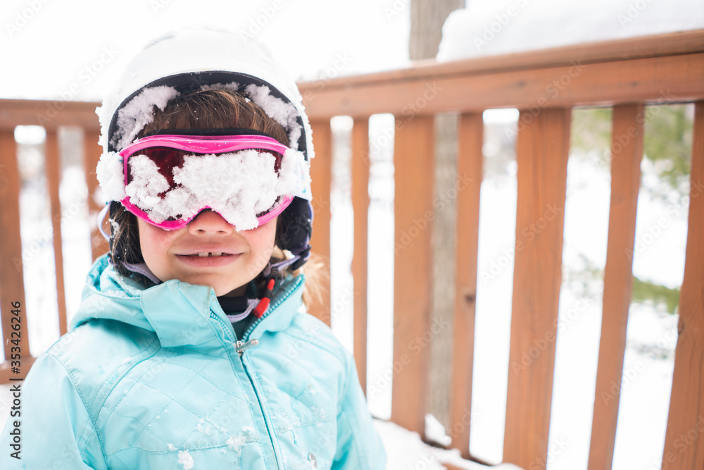 Portrait of young girl with snow covered ski goggles Portrait of young girl with snow covered ski goggles