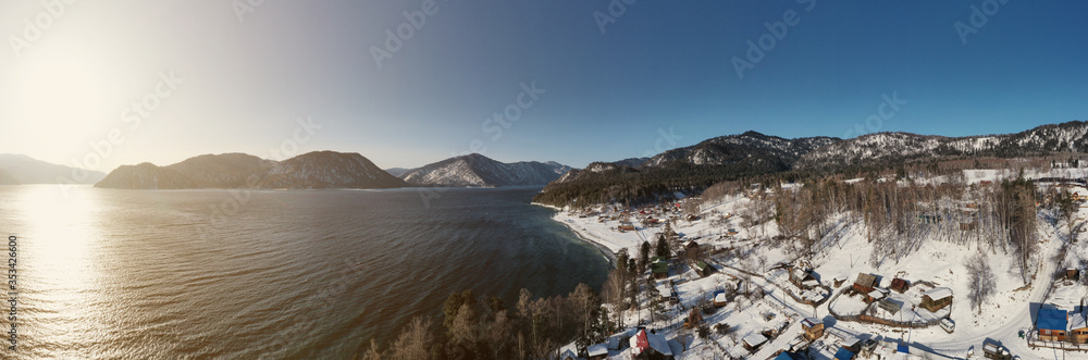 Aerial view panorama of mountain lake in winter sunny day