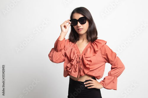 Portrait of a beautiful young asian girl in sunglasses .