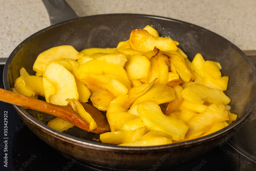 wok with apple slices cooked for pie wok with apple slices cooked for pie