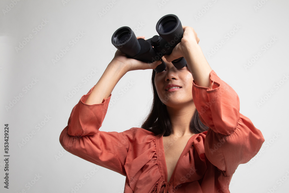 Young Asian woman with binoculars . Young Asian woman with binoculars .