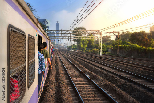 Obraz na płótnie Mumbai, India, Due to overcrowding, people travel in open doors. Mumbai Suburban Railway known as Super-Dense Crush Load and most severe overcrowding in the world w salonie