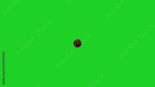 American football thrown by a quarterback on a green screen background