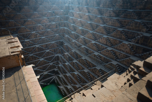 .Perspective stone stairs of the famous and deepest Chand Baori Step Well in Abhaneri, Rajasthan, India. Stepwells in which the water is reached by descending a set of steps to the water level photo