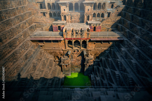 .Perspective stone stairs of the famous and deepest Chand Baori Step Well in Abhaneri, Rajasthan, India. Stepwells in which the water is reached by descending a set of steps to the water level photo