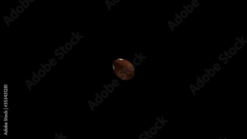 American football spinning in the air on a black screen background