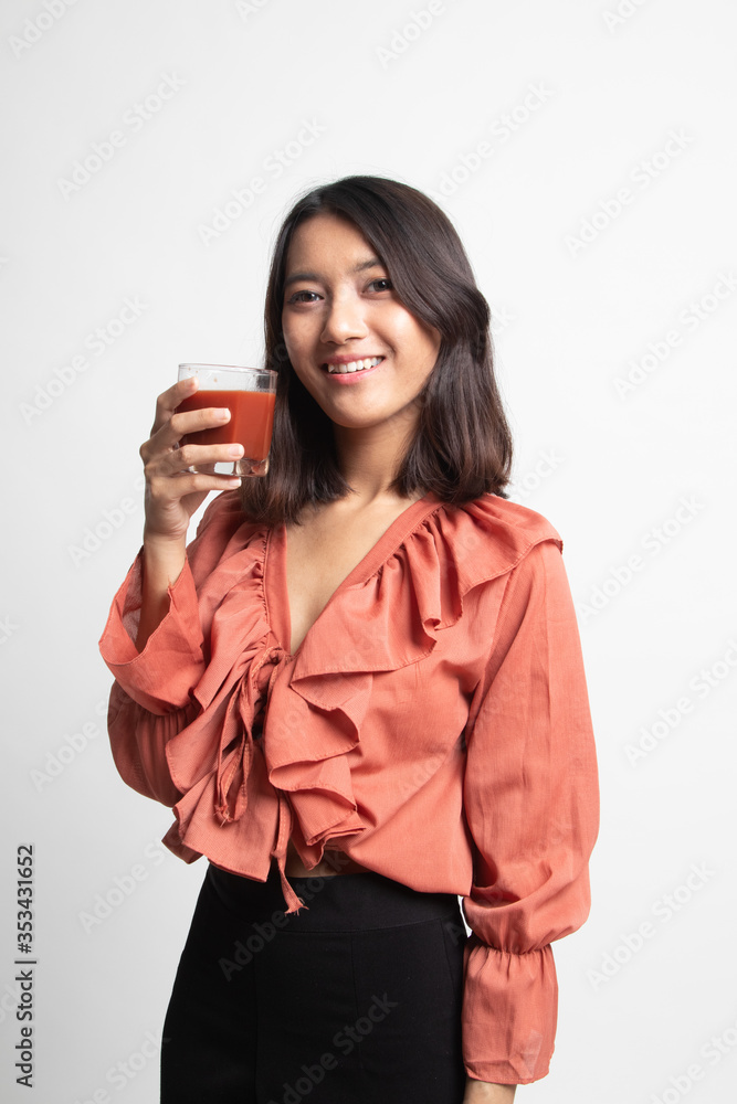 Fototapeta premium Young Asian woman drink tomato juice .