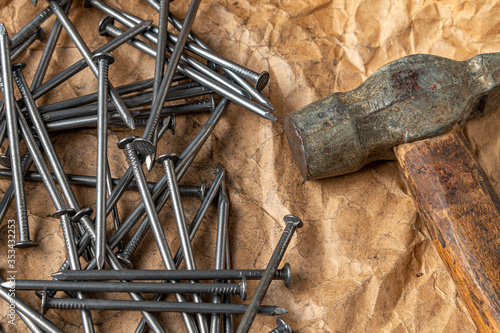 Vintage hammer with nails on papper