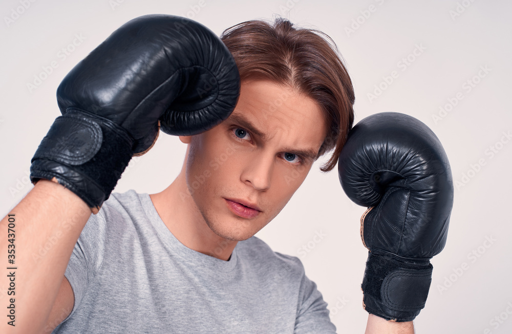 Portrait of a young athletic boxing guy in gloves. Portrait of a young athletic boxing guy in gloves.