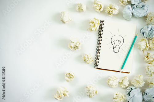 new ideas concept. notebook with three bulb, paper balls, samrtphone, laptop, pencil. copy space