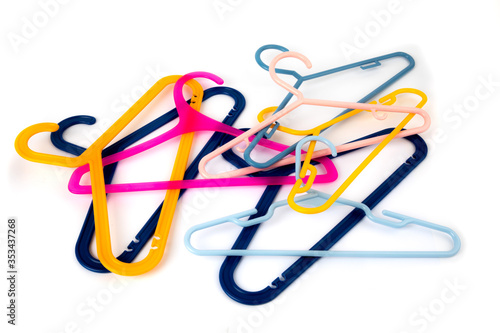 a pile of colorful plastic clothes hangers isolated on white