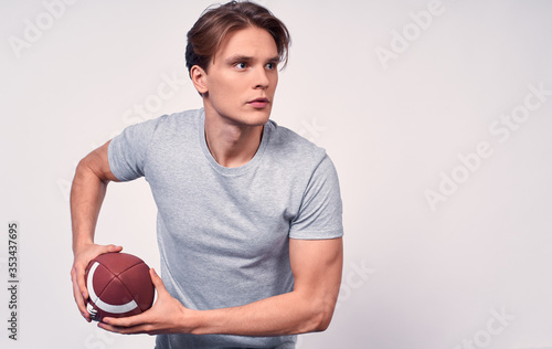 A young football player ready to throw his football.