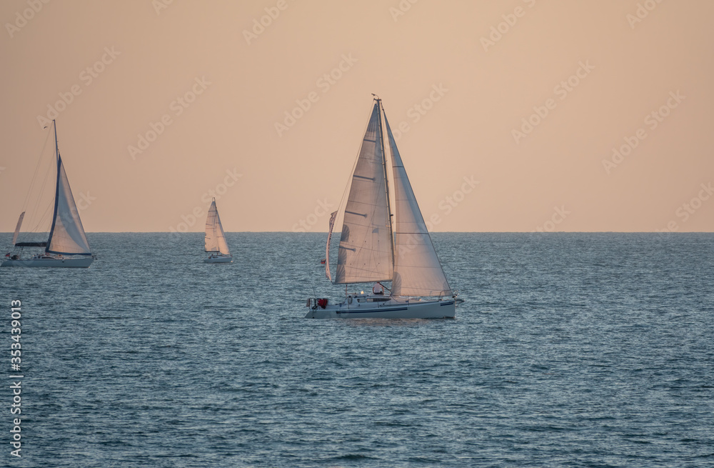 Sailing yachts in the blue calm sea.