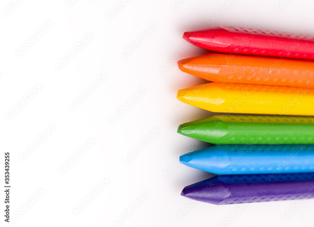 The concept of children's creativity drawing. Crayons on a white background copy space. The concept of children's creativity drawing. Crayons on a white background copy space.