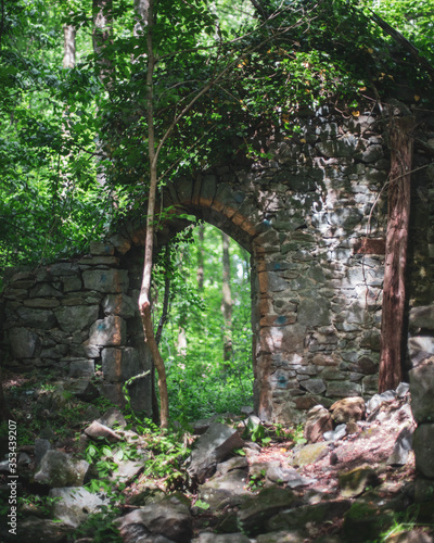 The remaining walls of an abandoned church in a dense Maryland forest