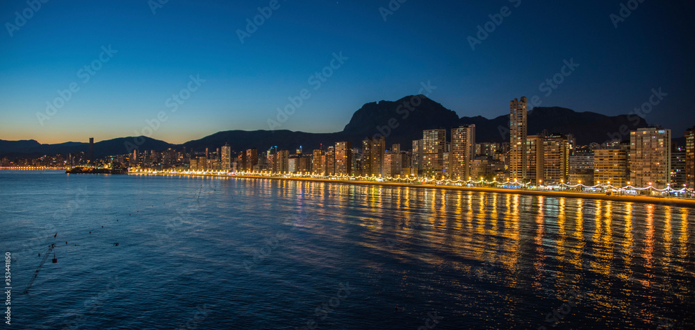 Night city by the sea with an empty beach and beautiful night lighting, Summer background