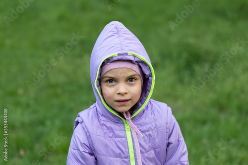 Portrait of little beautiful girl with big eyes outdoors