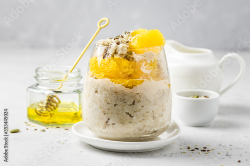 Coconut cream overnight oatmeal breakfast in glasses. Slective focus, copy space.