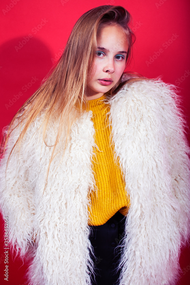 young pretty fashion teenage girl on bright red background holding donut, happy smiling lifestyle people concept young pretty fashion teenage girl on bright red background holding donut, happy smiling lifestyle people concept