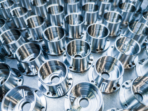 Bild auf Leinwand a batch of shiny metal cnc aerospace parts production - close-up with selective