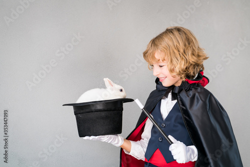 Fényképezés Child illusionist with cute rabbit