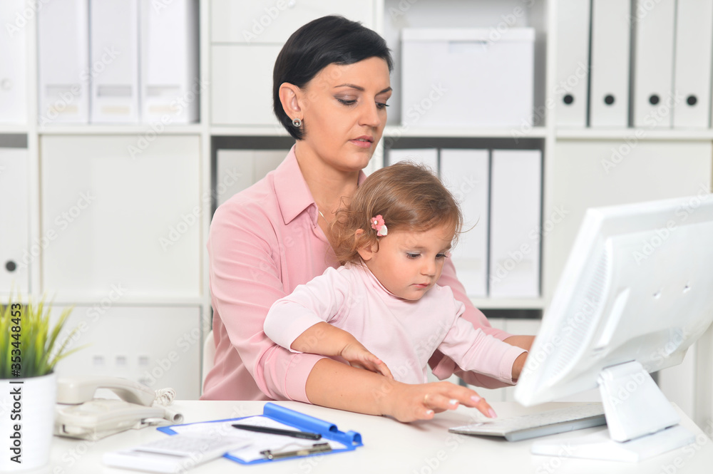 Businesswoman with her child working in office Businesswoman with her child working in office