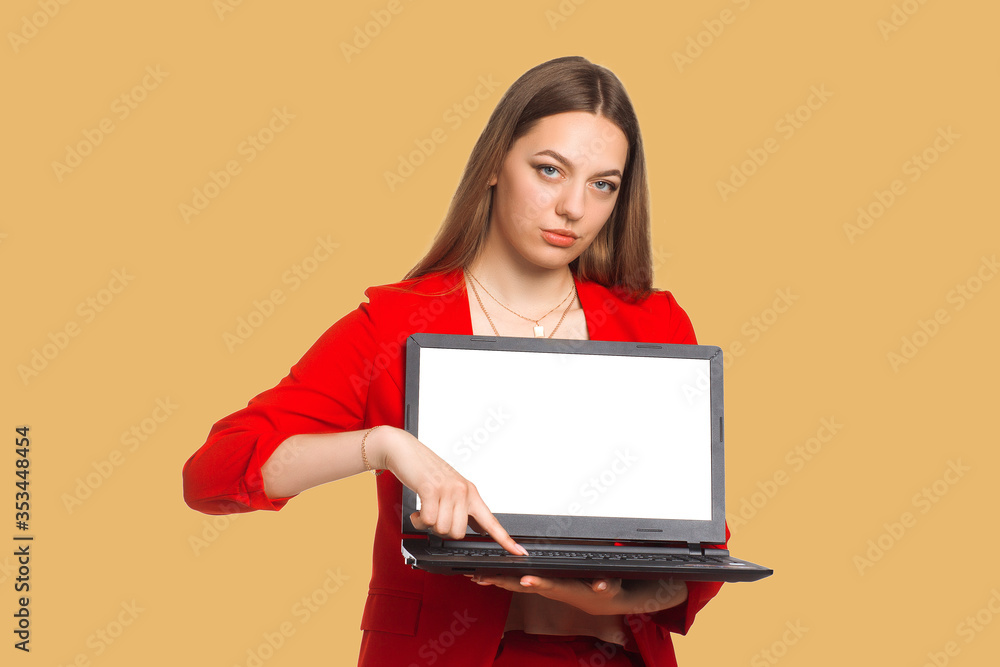 Naklejka premium office woman looking at camera , Holding a laptop, shows a finger at him