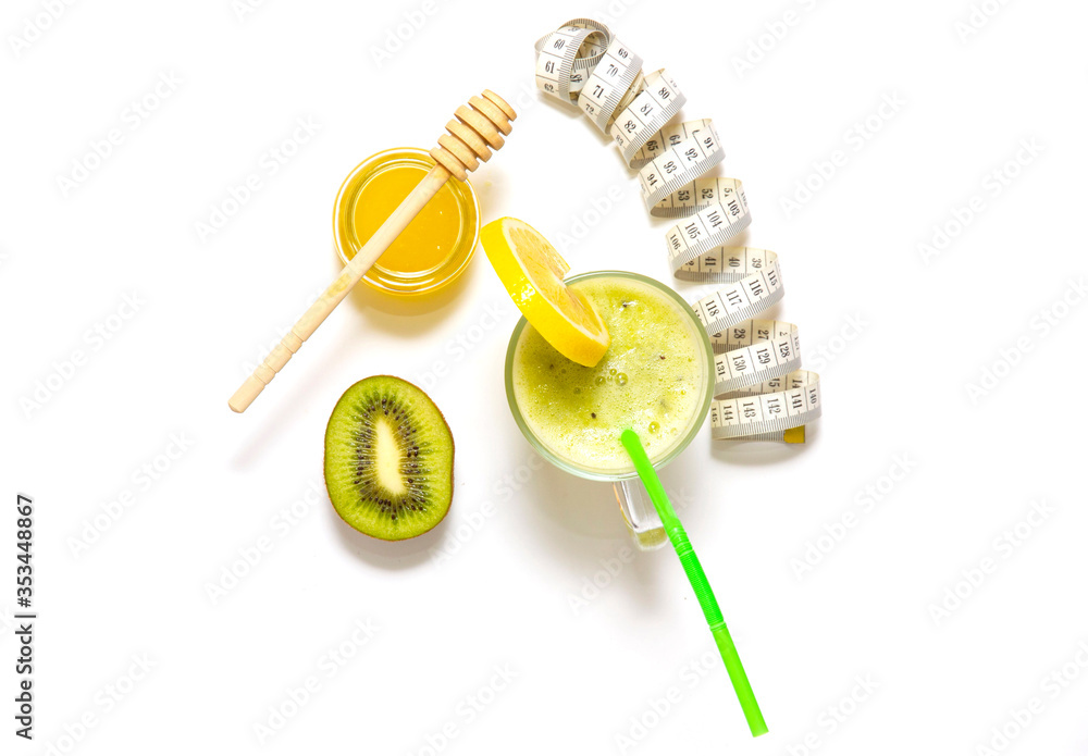 smoothies made of kiwi and honey, with a slice of lemon on a glass, straws for a cocktail. top view. smoothies made of kiwi and honey, with a slice of lemon on a glass, straws for a cocktail. top view.