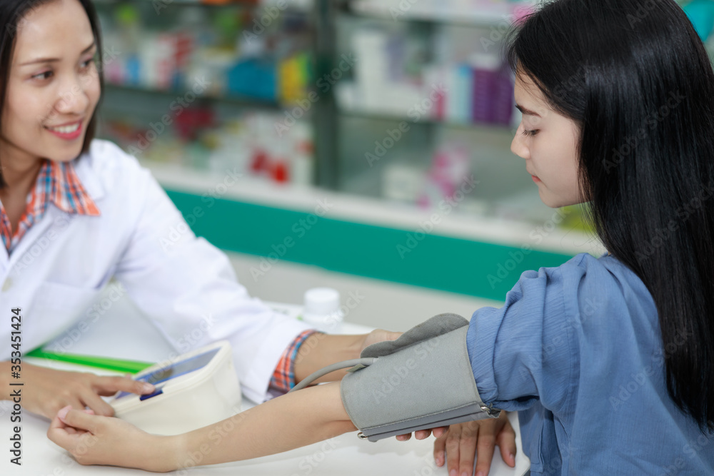 Doctor using Blood pressure monitor and checking measuring Doctor using Blood pressure monitor and checking measuring