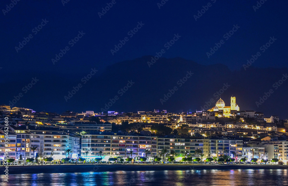 Night city by the sea with an empty beach and beautiful night lighting, Summer background