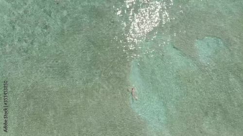 Cenital view of a women swimming in the sea
