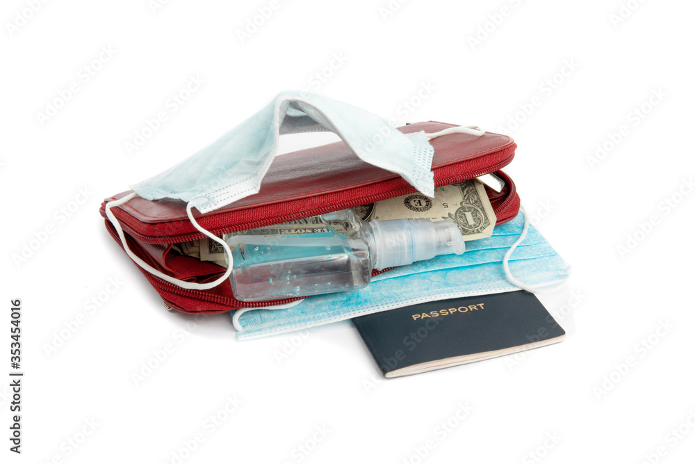travel preparations, passport and a bottle of hand sanitizer and surgical masks to help prevent the spread of infection like corona virus travel preparations, passport and a bottle of hand sanitizer and surgical masks to help prevent the spread of infection like corona virus