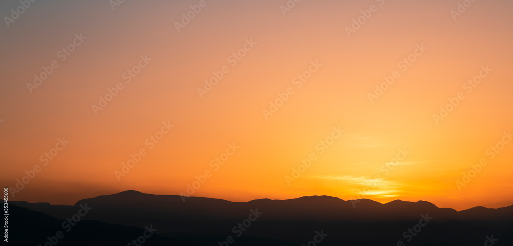 Beautiful bright sunrise sky over the mountains silhouette . Nature backgrounds Beautiful bright sunrise sky over the mountains silhouette . Nature backgrounds