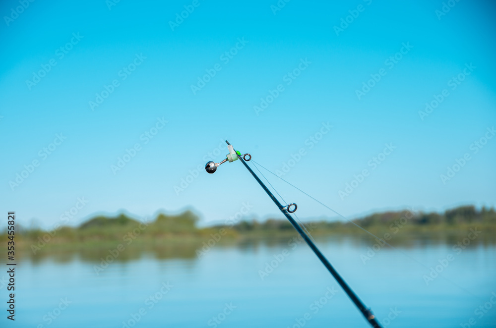 Fishing rod with bell end, blue sky Fishing rod with bell end, blue sky