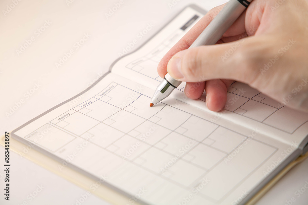 Closeup of hand writing on schedule planner. Selective focus on tip of pen.
Concept of planning and time management. Closeup of hand writing on schedule planner. Selective focus on tip of pen.
Concept of planning and time management.