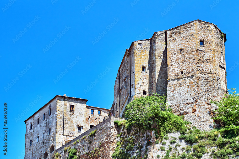 Stone, historic houses on a rocky cliff in the city of Sorano, Tuscany, Italy. Stone, historic houses on a rocky cliff in the city of Sorano, Tuscany, Italy.