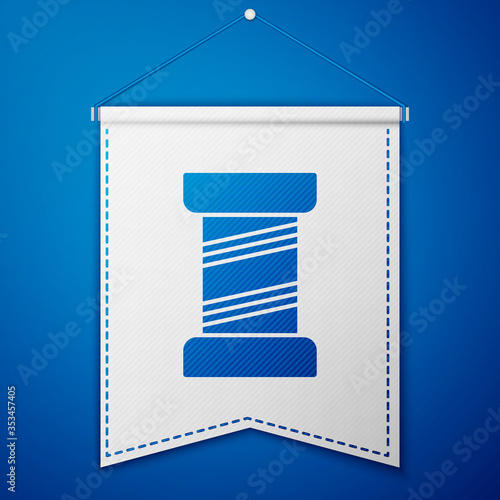 Blue Sewing thread on spool icon isolated on blue background. Yarn spool. Thread bobbin. White pennant template. Vector Illustration.