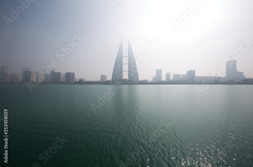 MANAMA, BAHRAIN - DECEMBER 29: The Bahrain World Trade Center during a foggy day. The iconic building is the first skyscraper in the world to have wind turbines, December 29, 2017, Manama, Bahrain