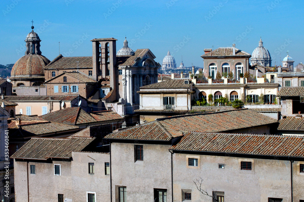 stunning view of roofs and many domes of churches in the historical center of Rome Italy