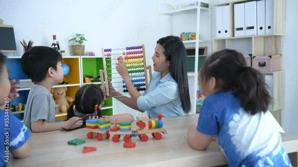 Educational concepts. The teacher is teaching math with abacus for kindergarten children in the classroom. 4k Resolution. Educational concepts. The teacher is teaching math with abacus for kindergarten children in the classroom. 4k Resolution.