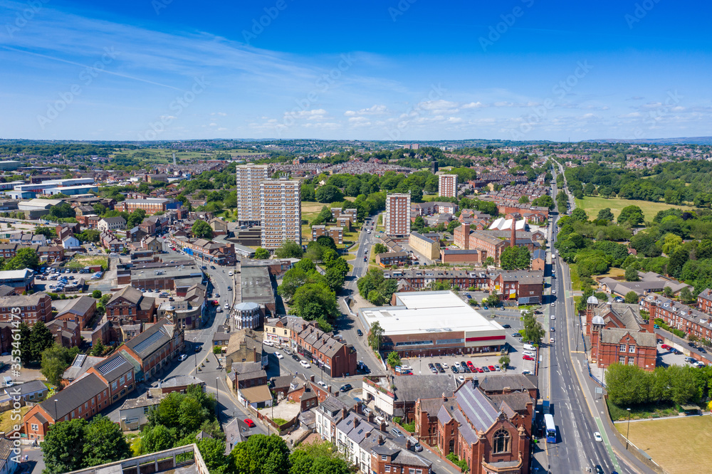 Aerial photo of the town centre of Armley in Leeds West Yorkshire on a bright sunny summers day showing apartment blocks flats and main roads going in to the town