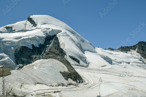 Tourists enjoying sunny day on Mittelallalin above the Saas-Fee in Switzerland photo