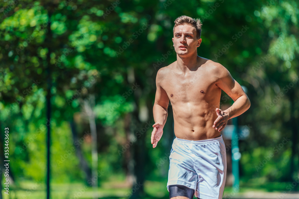 Close-up portrait of a handsome male athlete running shirtless on a sunny day Close-up portrait of a handsome male athlete running shirtless on a sunny day