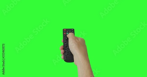 Isolated Male hand with TV remote pressing button and changing, switch channels. Green screen. Place for your advertisement. Pack of Gestures. Using a remote control over keyed chroma key background
