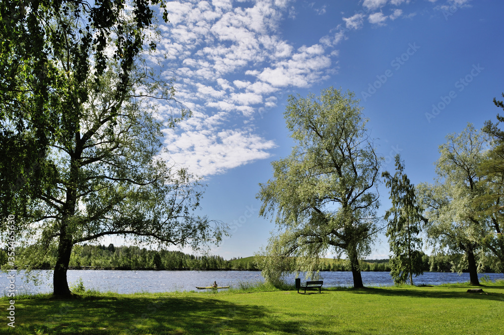 Boating in Natural Lake Surrounded by Forest, Grassland and Trees in Joensuu, Northern Karelia, Finland at Summer Morning in July 2019 Boating in Natural Lake Surrounded by Forest, Grassland and Trees in Joensuu, Northern Karelia, Finland at Summer Morning in July 2019