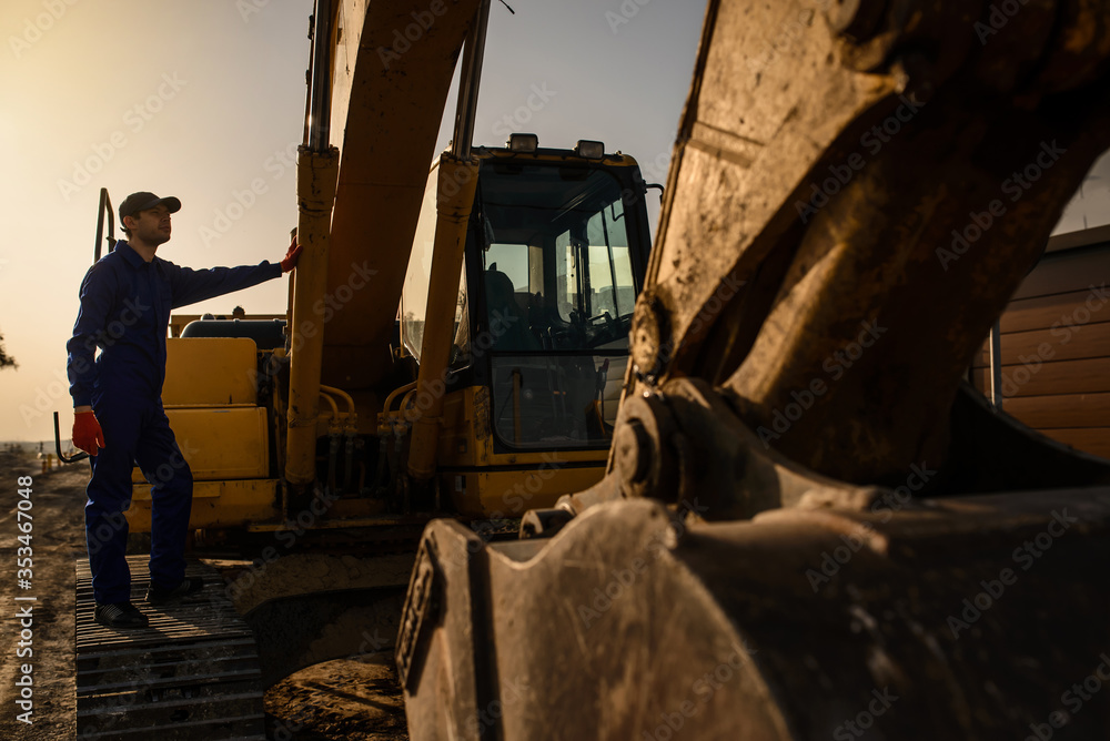 Fototapeta premium A contractor builder is sitting near bulldozer